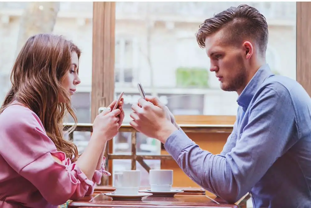 Couple busy in phone on first date